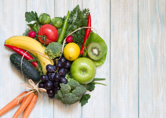 Wall Mural - Bouquet of fresh fruits and vegetables on wooden board healthy diet lifestyle concept