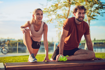 Modern couple doing exercise in urban area.