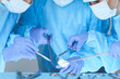 © rogerphoto - Close-up of medical team performing operation. Group of surgeons at work are busy of patient. Medicine, veterinary or healthcare and emergency in hospital