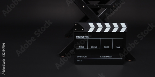 clapper board or movie slate  and director chair use in video production and cinema industry on black background.