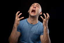Photo Of Screaming Shaved Man In Blue Tee Shirt