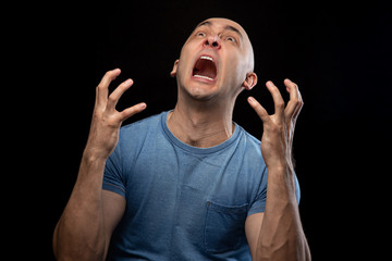 Wall Mural - Photo of screaming shaved man in blue tee shirt