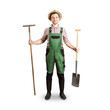 Happy gardener holding a rake and a spade - white background