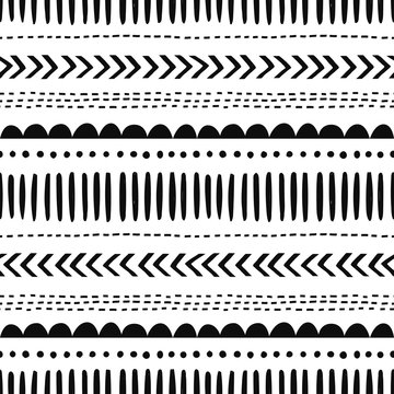 African hand drawn vector seamless pattern. Geometrical black doodle shapes on white background. Dot, zigzag, dash line decorative backdrop. Monochrome wrapping paper, wallpaper design