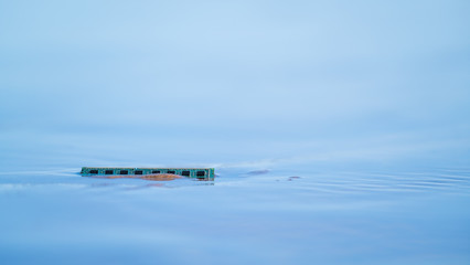 Memory card against a background of calm blue surf on the shores of a sandy beach