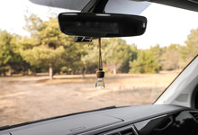 Air Freshener Hanging On Rear View Mirror In Car