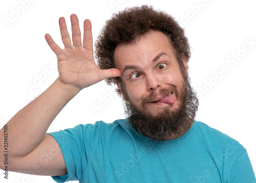 Fotografía Emotional portrait of bearded man with Curly Hair, shows tongue, isolated on white background