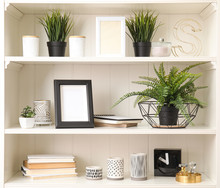 White Shelving Unit With Plants And Different Decorative Stuff
