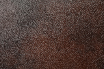 Texture of dark brown leather as background, closeup