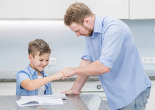 Father Praises Son For Well Done Homework