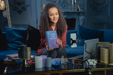 smiling young video blogger talking about astrology
