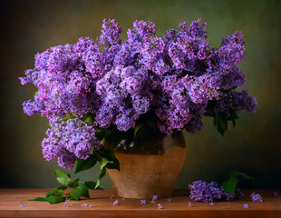 Still life with a bouquet of lilacs on the table