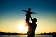 © Kostia - silhouette of father and son  on sunset