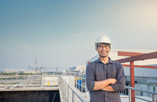 Portrait Asian Man Engineer Smiling Cross Arm On Cat Walk Near Waste Water Treatment Plant In Factory.