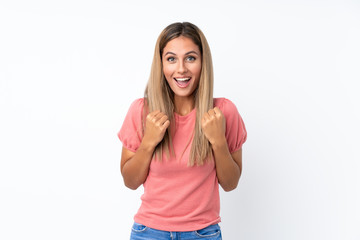 Young blonde woman over isolated white background celebrating a victory in winner position