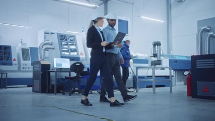 Aufkleber - Female Chief Engineer and Male Project Manager Walk Through Modern Factory, Talking and Planning Optimization of the Production. Industrial Facility: Professionals Working on CNC Machinery, robot arm