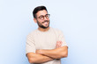 © luismolinero - Young handsome man with beard over isolated blue background laughing