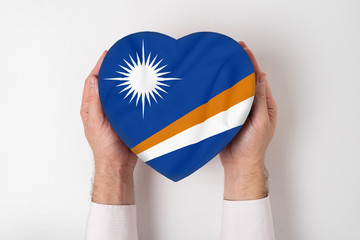 Wall Mural - Flag of Marshall Island a heart shaped box in a male hands. White background