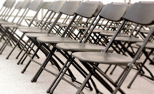 A Group Of Black Folding Chairs