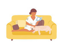 Woman On Yellow Sofa Reading Book And Petting Dog
