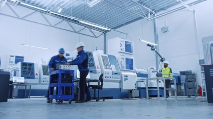 Fototapete - Indusry 4.0 Factory: Team of Engineers, Professionals and Workers, Working on Assembly and Production Line, Optimizing CNC Machinery, Programming Machines, Talking and Planning Projects. Time-Lapse 
