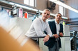 © Westend61 - Two businessmen in a printing shop looking around