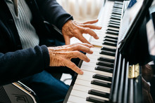 Crop View Of Senior Man Playing Piano