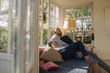 © Westend61 - Affectionate couple relaxing in sunroom at home