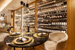 © Westend61 - Interior of a fancy restaurant with wine cabinet