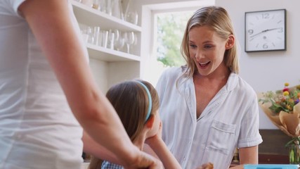 Wall Mural - Same Sex Female Couple With Daughter Preparing Meal At Home Together