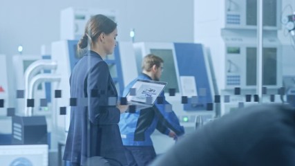 Poster - 
Modern Factory: Confident Female Engineer Walks Through Facility, Holding Laptop, Inspecting and Monitoring Workshop Workings. Manufactory Has Professionals Working on CNC Machinery, Robot Arm
