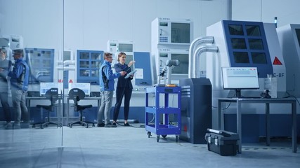 Poster - Modern Factory: Female Project Manager and Male Engineer Standing, Talking and Using Tablet Computer for Programming Robot Arm Assembly Line. Contemporary Facility with High Tech CNC Machinery