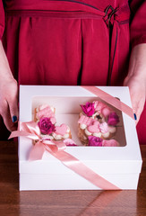 Wall Mural - The hands of the confectioner with a delicate and delicious cake of letters.