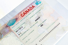 Canadian Working Visa In Passport. Immigration To Canada Concept.