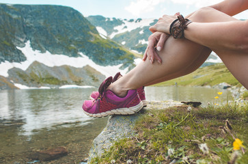 Tourists legs near beautiful lake