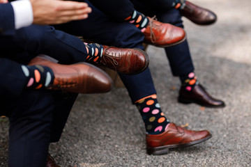 stylish men's socks. Stylish suitcase, men's legs, multicolored socks and new shoes. Concept of style, fashion, beauty and vacation