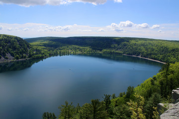 Beautiful Wisconsin late spring nature background. Areal view on the lake from West Bluff rocky ice age hiking trail. Devil's Lake State Park, Baraboo area, Wisconsin, Midwest USA.