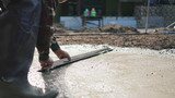 Fototapeta Tęcza - industrial worker Plastering concrete to build floor worker with plastering tools .professional of skilled labor construction industry.selective focus.