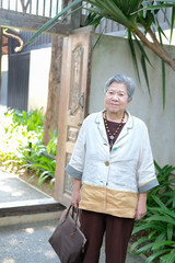 Wall Mural - old elder woman resting in garden. elderly female relaxing outdoors. senior leisure lifestyle