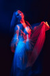 © alexkoral - blurry girl in a dress is dancing on a dark background