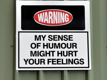 An Amusing Sign Attached To A Building Warning "My Sense Of Humour Might Hurt Your Feelings"