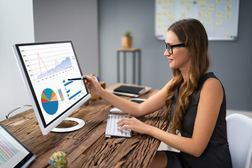 Poster - Businesswoman Analyzing Graph On Computer