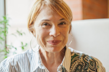 Smiling older woman with short ginger hair portrait