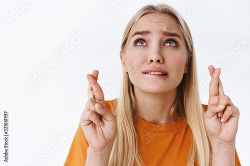 Photographie Close-up worried, very nervous blond caucasian woman in orange t-shirt, fingers