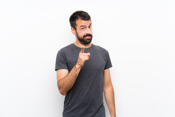Wall Mural - Young handsome man over isolated white background frustrated and pointing to the front