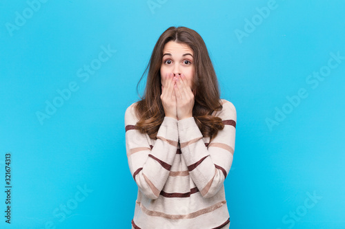 Cuadros en Lienzo young pretty woman feeling worried, upset and scared, covering mouth with hands,