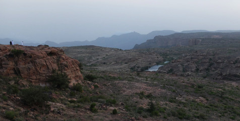 Two Saudi Men contemplating the landscape in Al Habala, Abha, Saudi Arabia