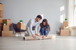 © Studio Romantic - Young couple family with boxes to move in a new house room.