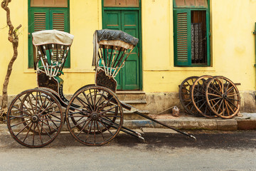 Hand pulled rickshaws are parkedon the street. Kolkata. India