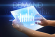 © ra2 studio - Hand holding futuristic tablet with DEMAND inscription above, modern business concept